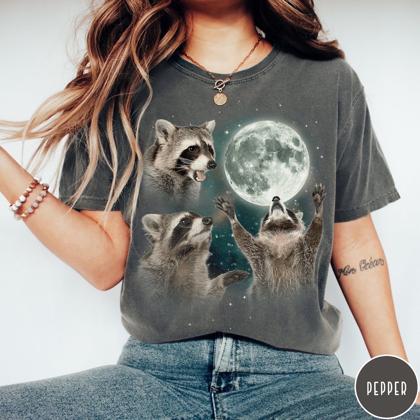 Comfort Colors tee in Pepper featuring artistic graphic of three raccoons reaching toward a bright full moon