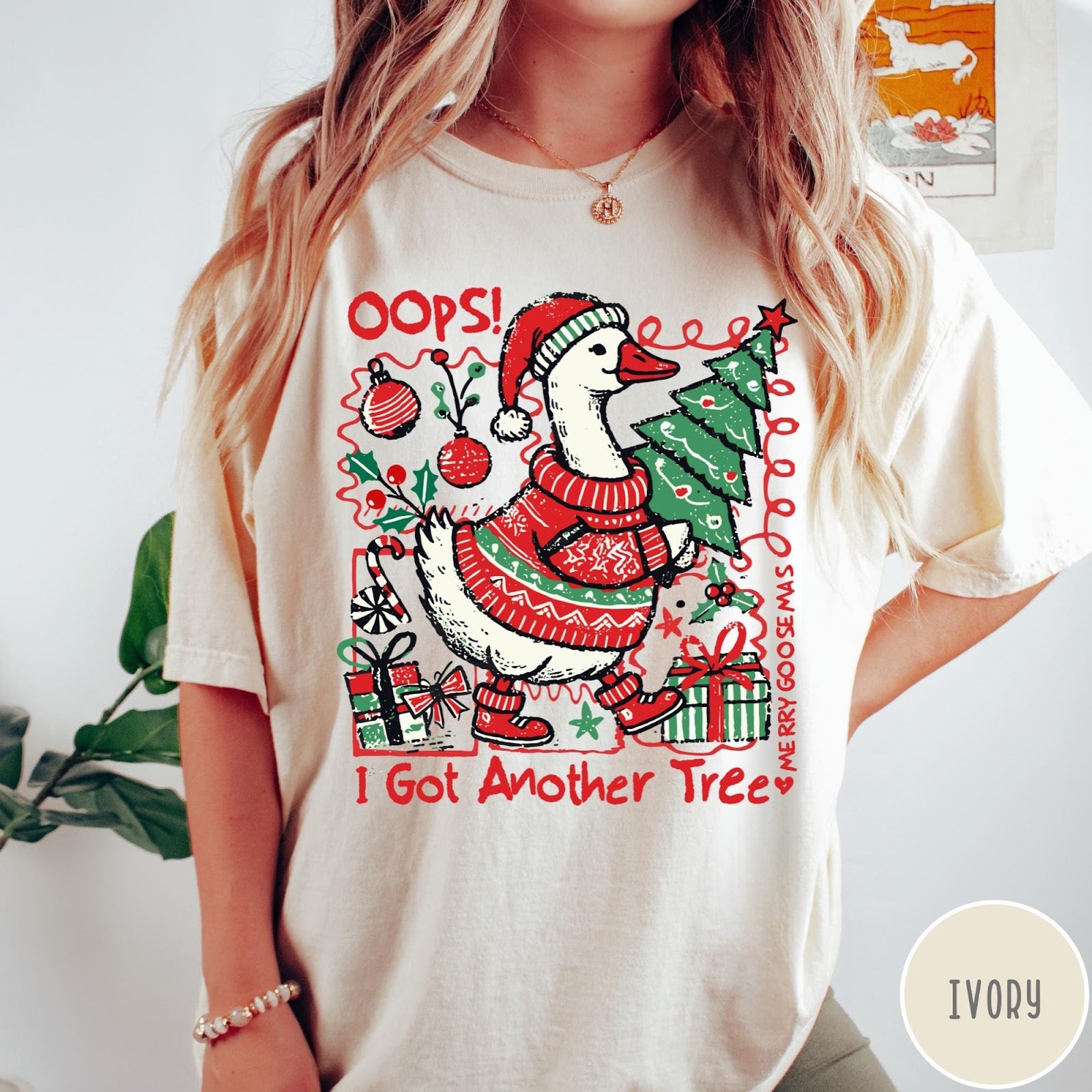 Comfort Colors tee in Ivory featuring festive graphic design of a goose wearing a sweater and hat