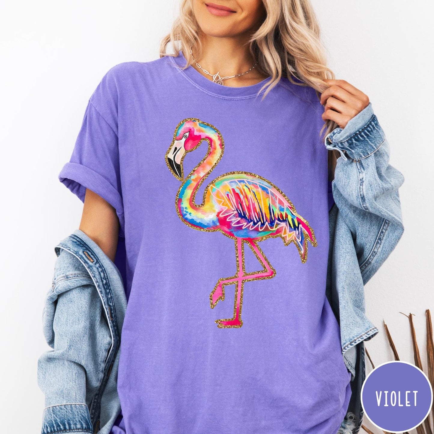 Comfort Colors tee in Violet featuring artistic watercolor flamingo graphic with gold glitter outline details