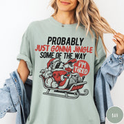 Comfort Colors tee in Bay featuring vintage style graphic of a tired raccoon in a Santa sleigh