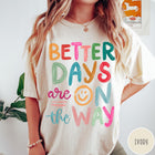 Comfort Colors tee in Ivory featuring optimistic typography with Better Days Are On The Way graphic text