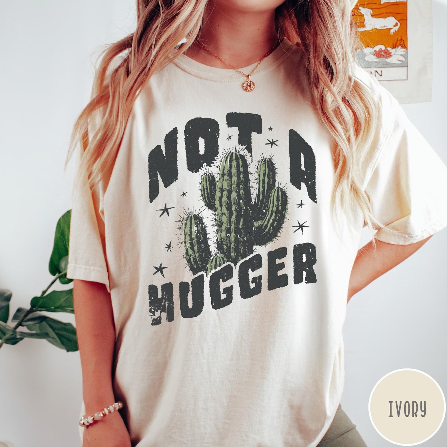 Comfort Colors tee in Ivory featuring cactus graphic and Not a Hugger text with small stars