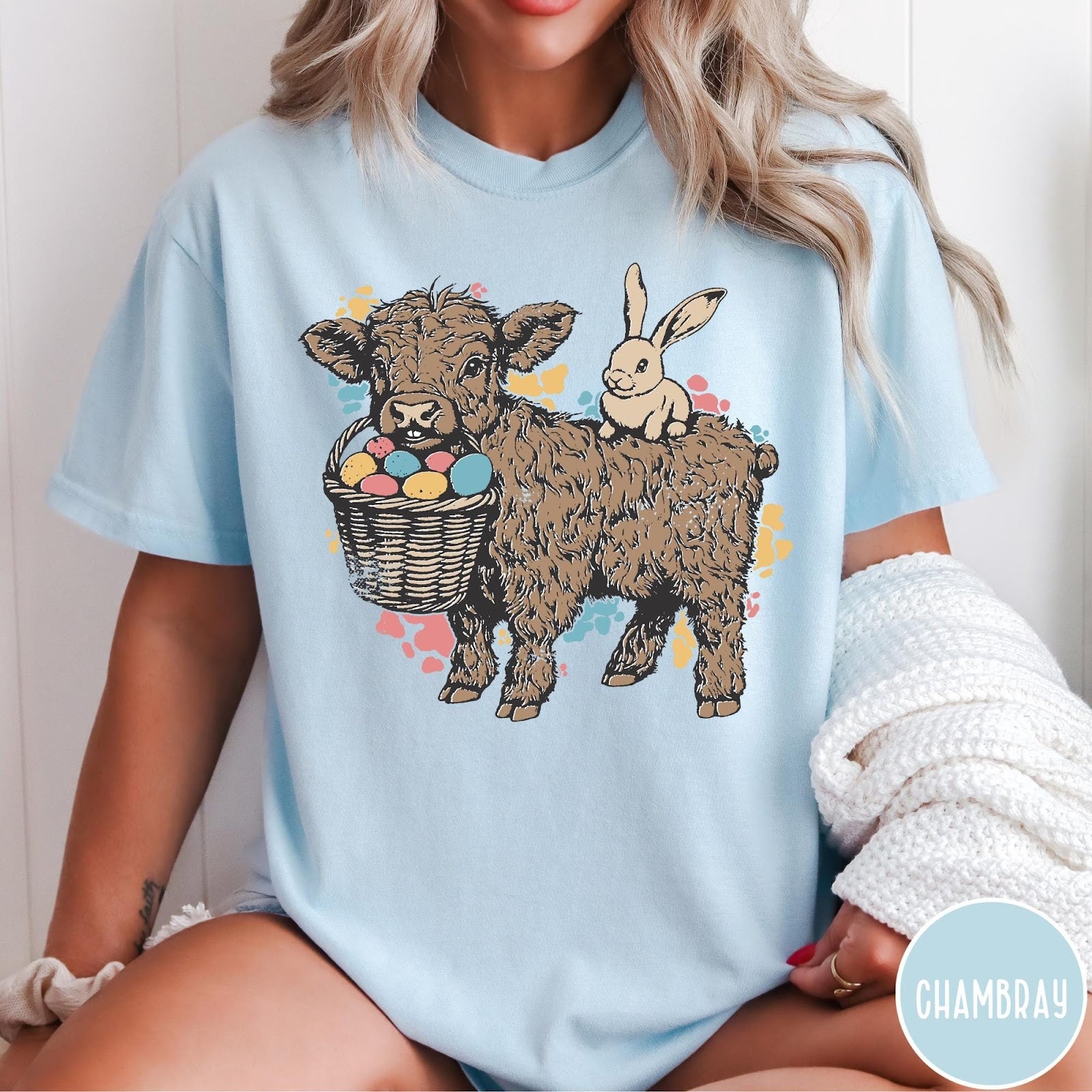 Comfort Colors tee in Chambray featuring graphic style Highland cow and bunny with an Easter egg basket