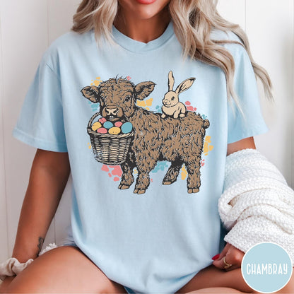 Comfort Colors tee in Chambray featuring graphic style Highland cow and bunny with an Easter egg basket