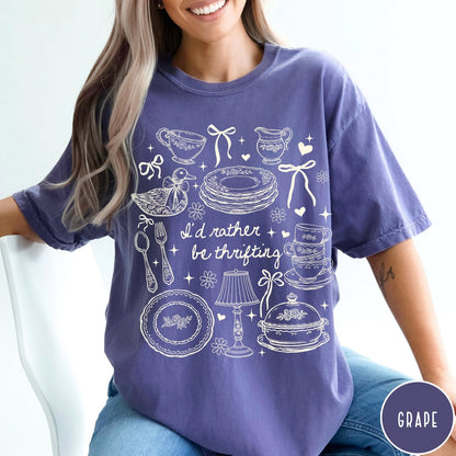 Comfort Colors tee in Grape featuring line art graphic of antique home goods and thrifting items