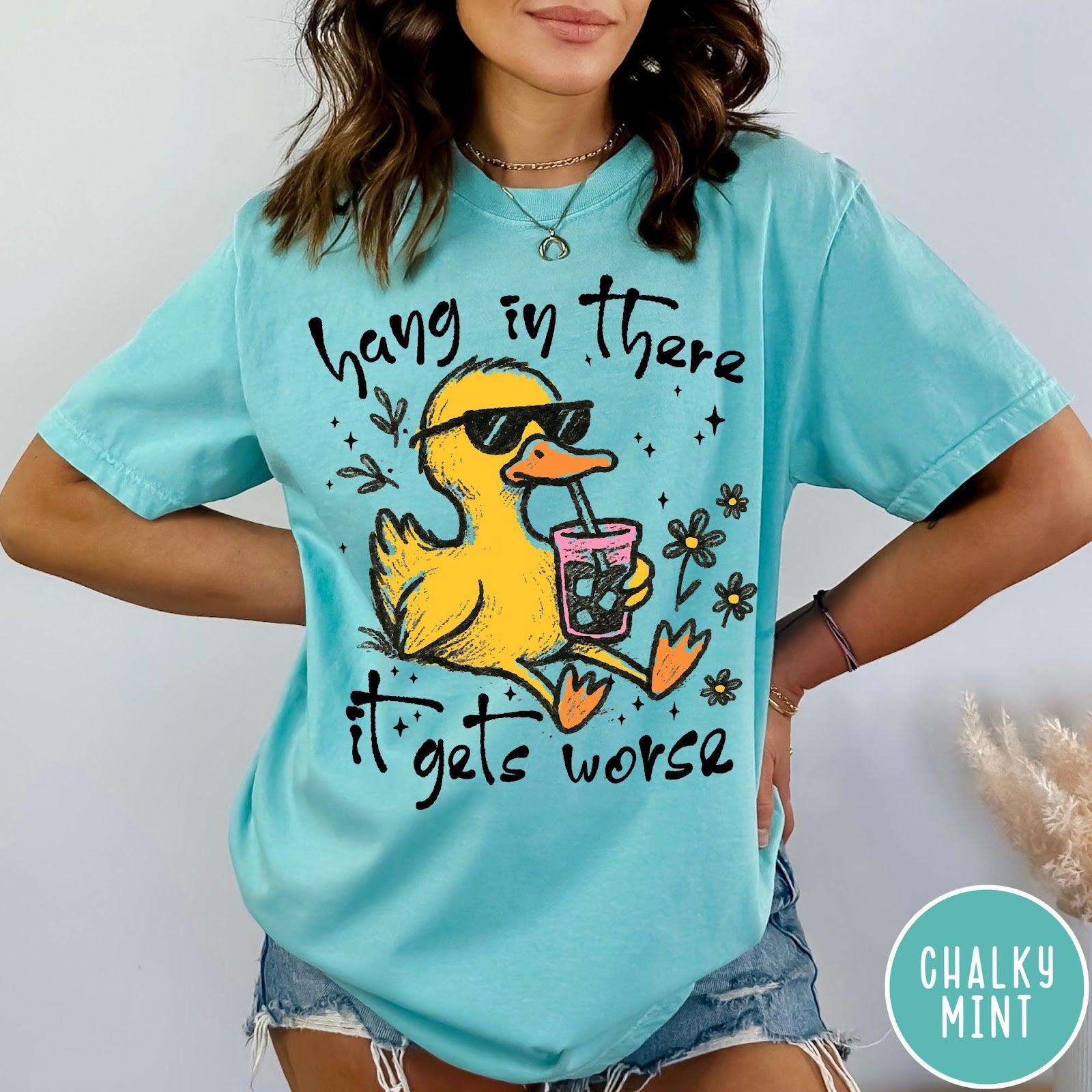 Comfort Colors tee in Chalky Mint featuring illustrated duck graphic wearing sunglasses and drinking a pink iced beverage