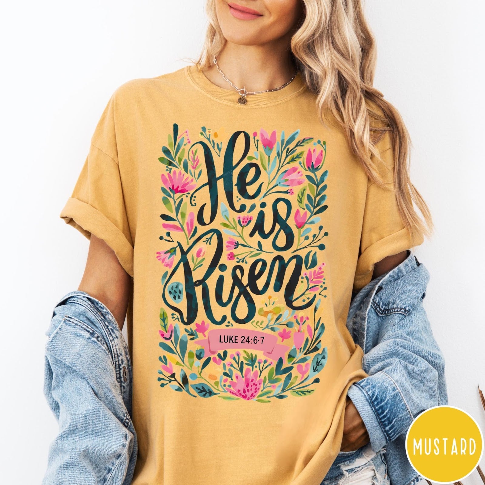 Comfort Colors tee in Mustard featuring Easter religious floral graphic with He is Risen and Luke 24:6-7 text