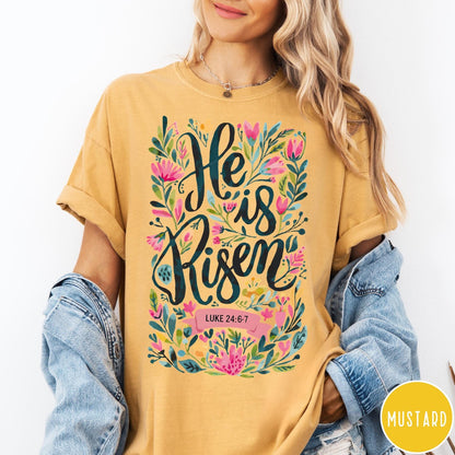 Comfort Colors tee in Mustard featuring Easter religious floral graphic with He is Risen and Luke 24:6-7 text