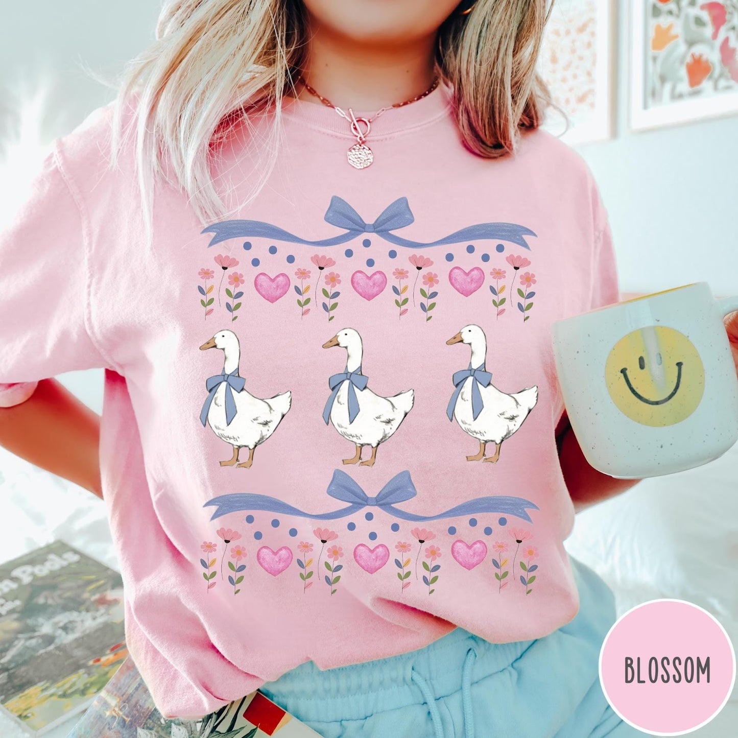 Comfort Colors tee in Blossom featuring vintage style graphic with three geese wearing blue bows and hearts