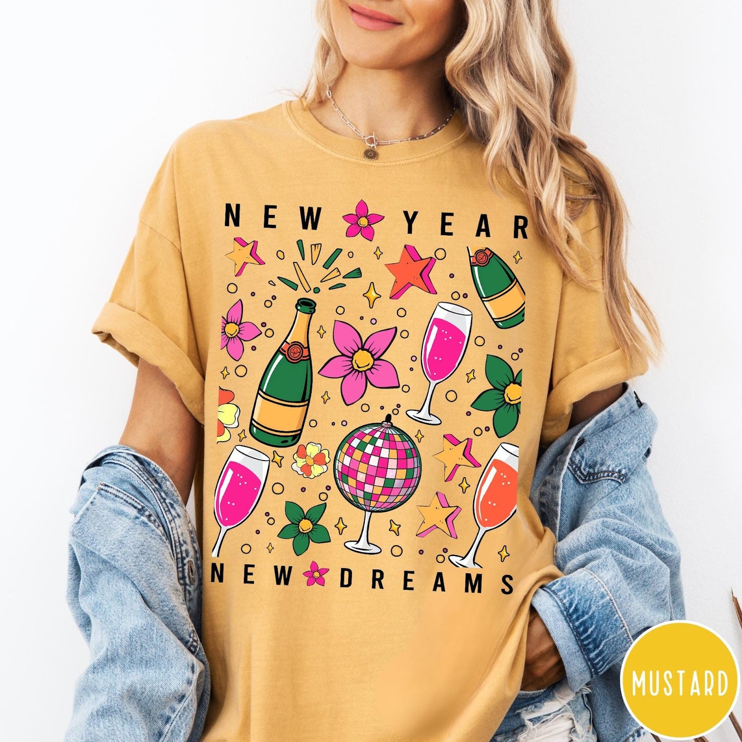 Comfort Colors tee in Mustard featuring New Year celebration graphic with champagne bottles, glasses, and disco ball