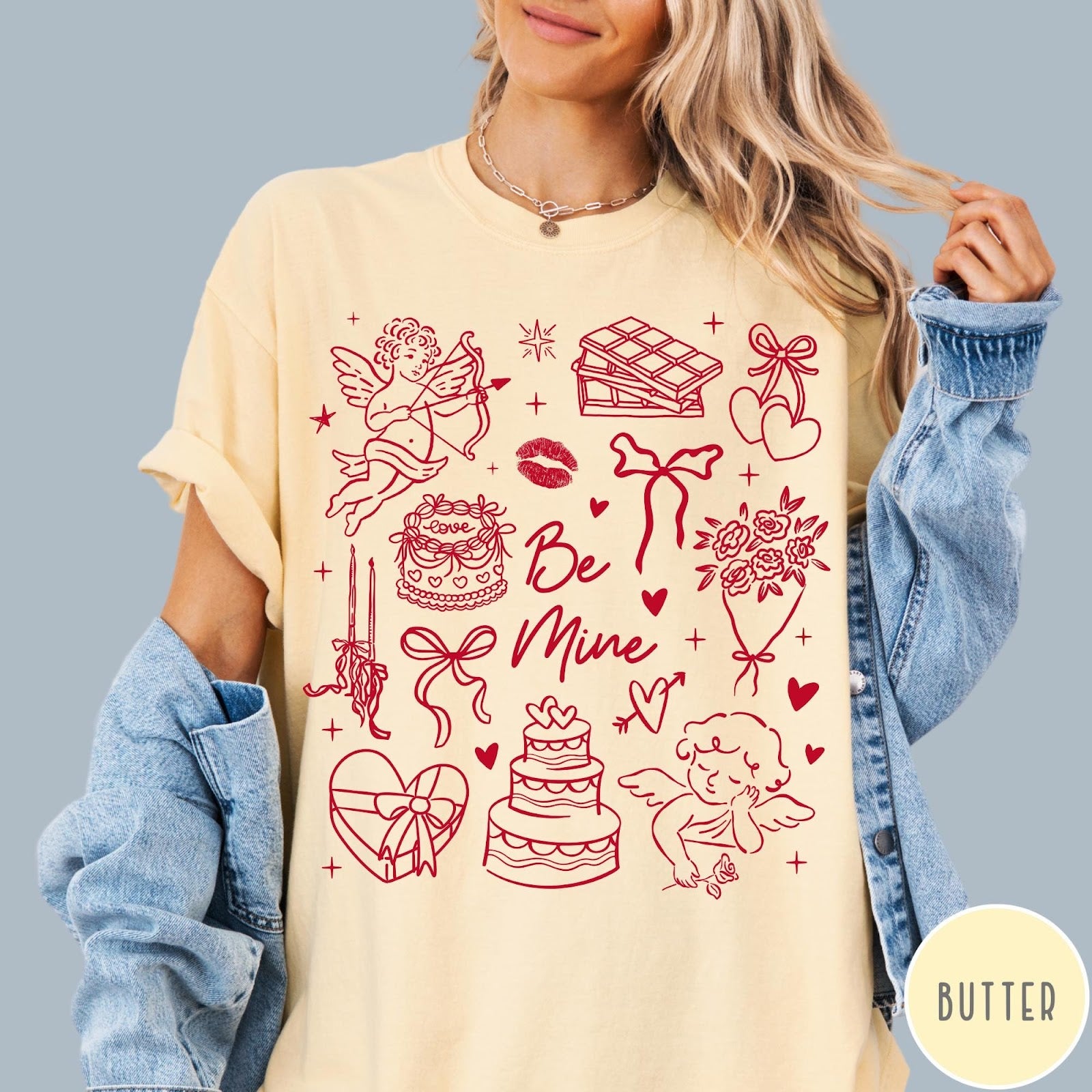 Comfort Colors tee in Butter featuring Valentine's Day collage graphic with cupid, cakes, and romantic symbols.