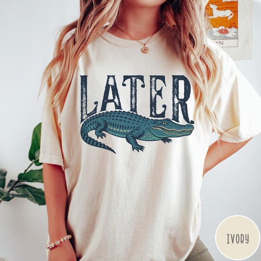 Comfort Colors tee in Ivory featuring casual style with a graphic of a green alligator and text