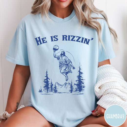 Comfort Colors tee in Chambray featuring graphic style Jesus playing basketball with mountains and pine trees illustration