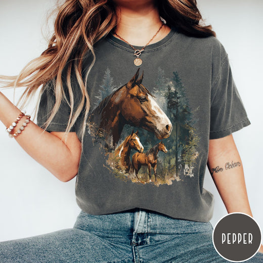 Comfort Colors tee in Pepper featuring vintage style graphic of three horses standing in a pine forest