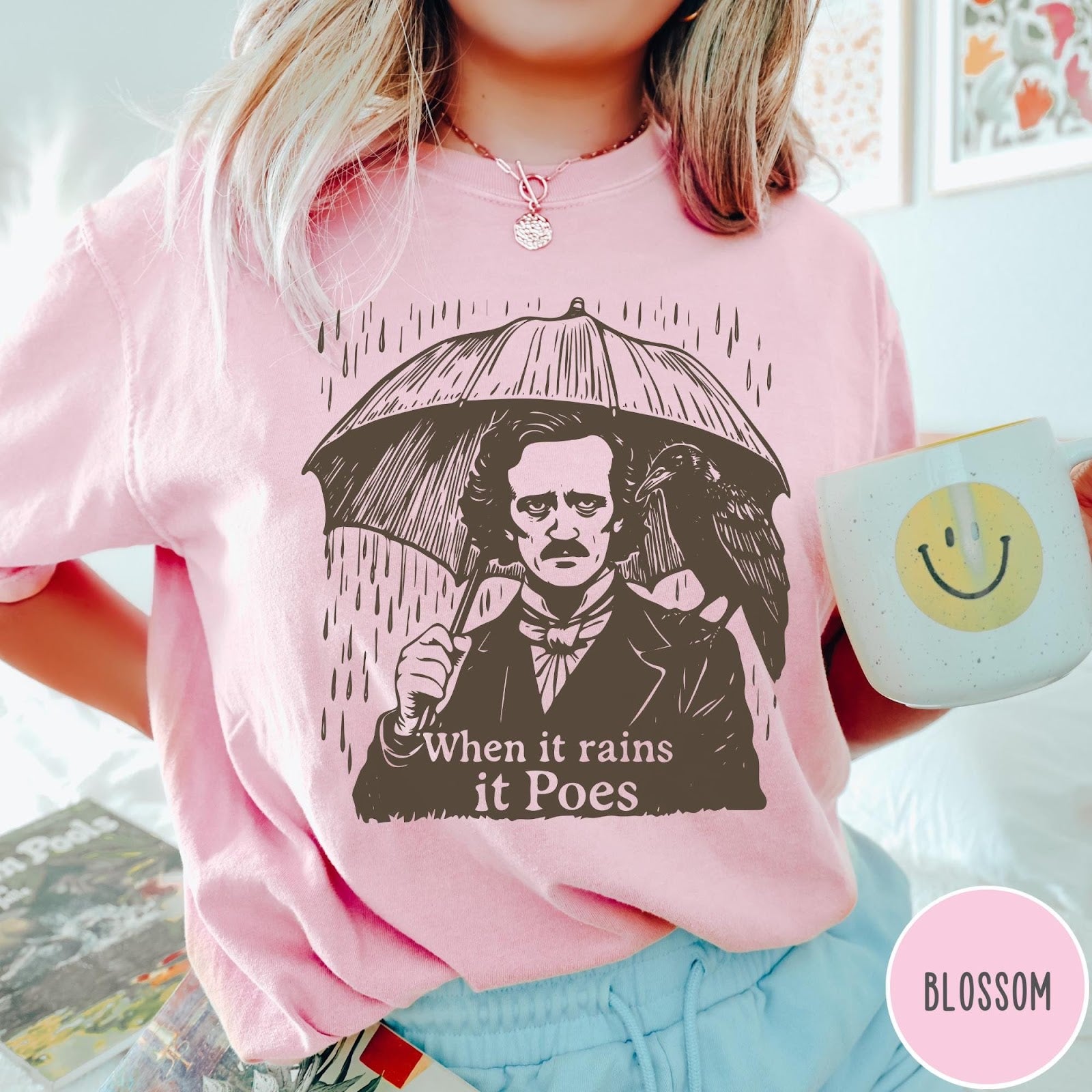 Comfort Colors tee in Blossom featuring graphic illustration of Edgar Allan Poe with umbrella and raven