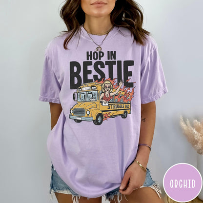 Comfort Colors tee in Orchid featuring retro style graphic of a woman waving from a burning school bus
