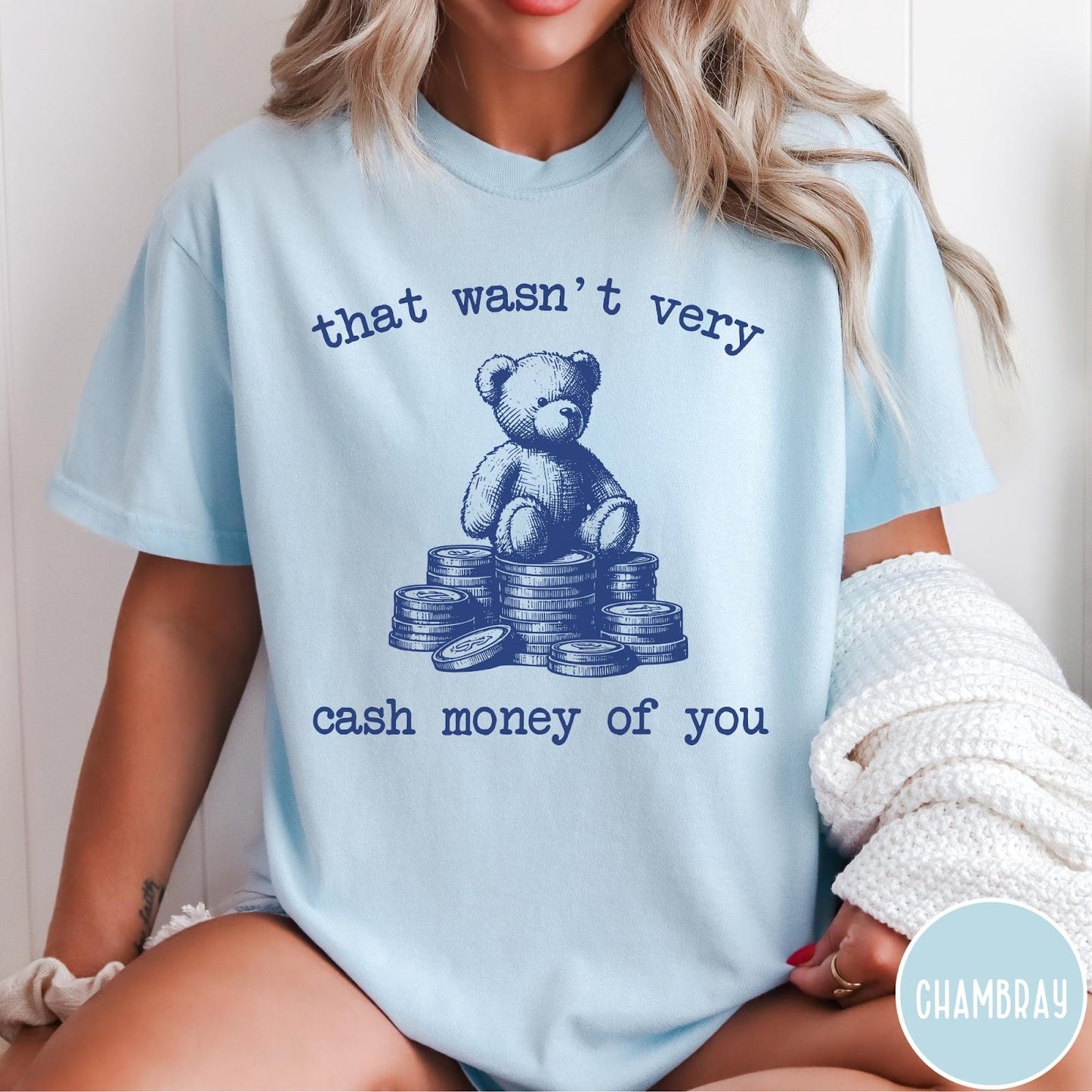 Comfort Colors tee in Chambray featuring graphic style teddy bear sitting on a stack of coins