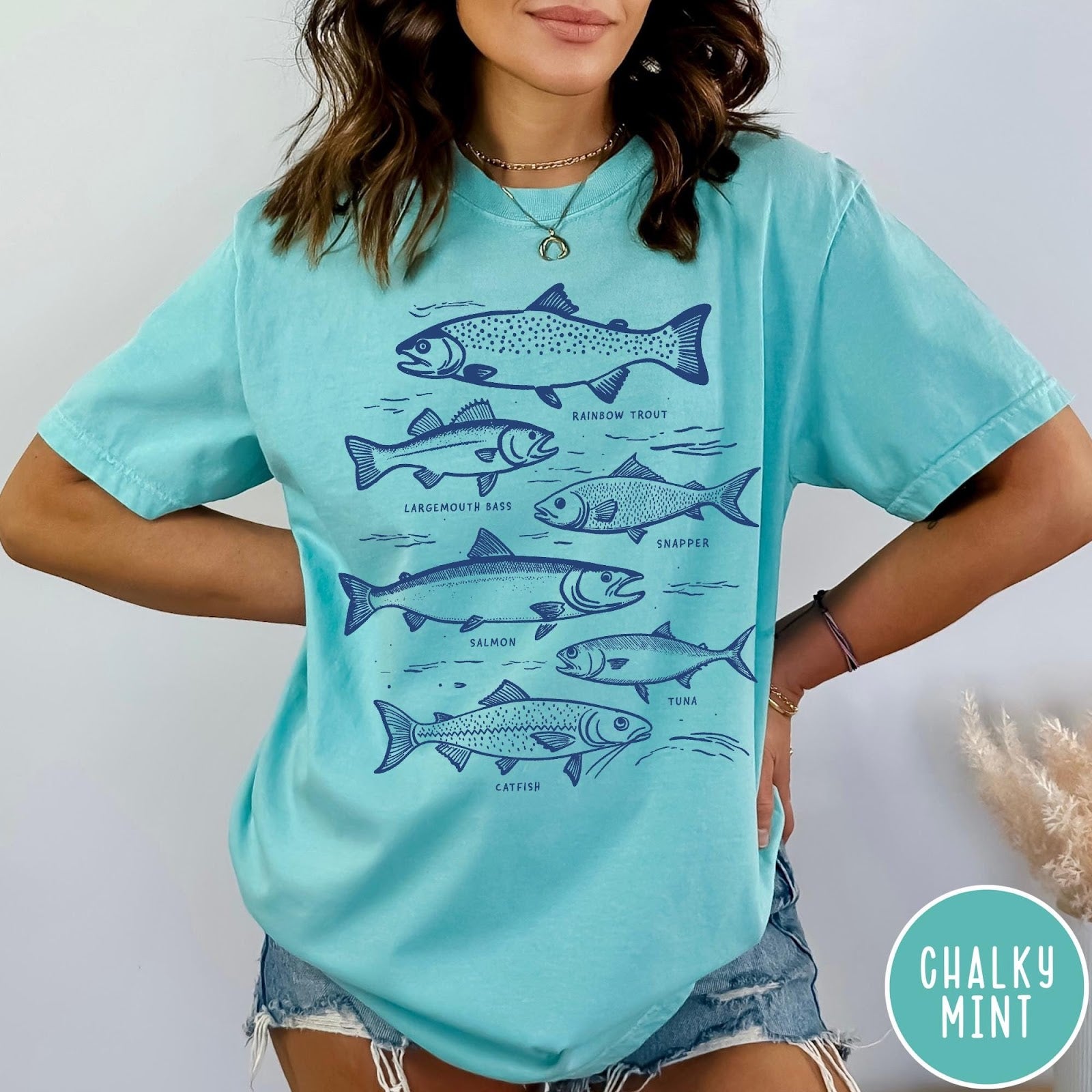 Comfort Colors tee in Pepper featuring vintage line illustration of various fish species with their names labeled.