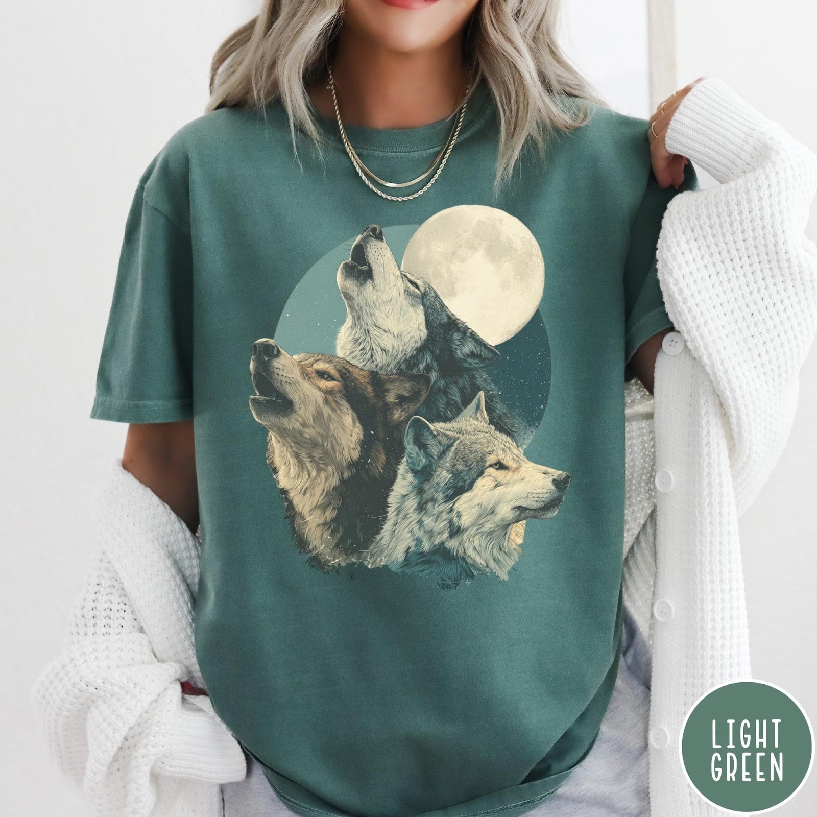 Comfort Colors tee in Light Green featuring vintage style graphic of three wolves howling at a full moon