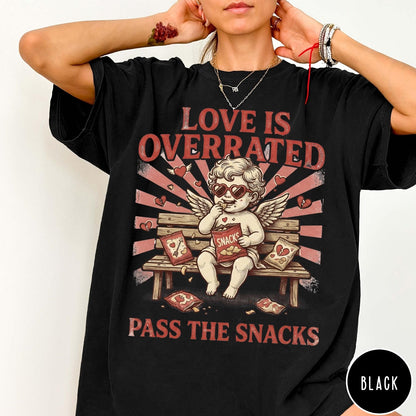 Comfort Colors tee in Black featuring vintage style graphic of a cherub eating snacks on a bench