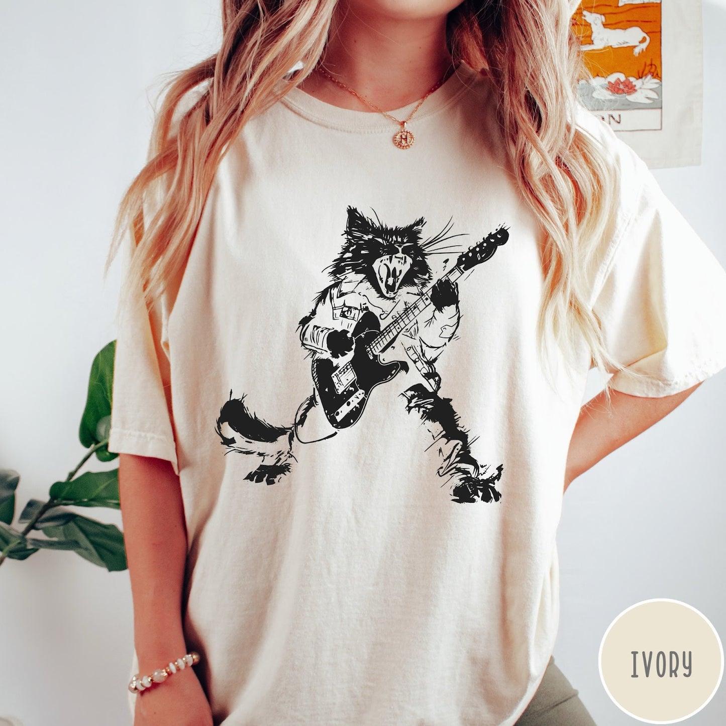 Comfort Colors tee in Ivory featuring rock music style graphic of a cat playing an electric guitar