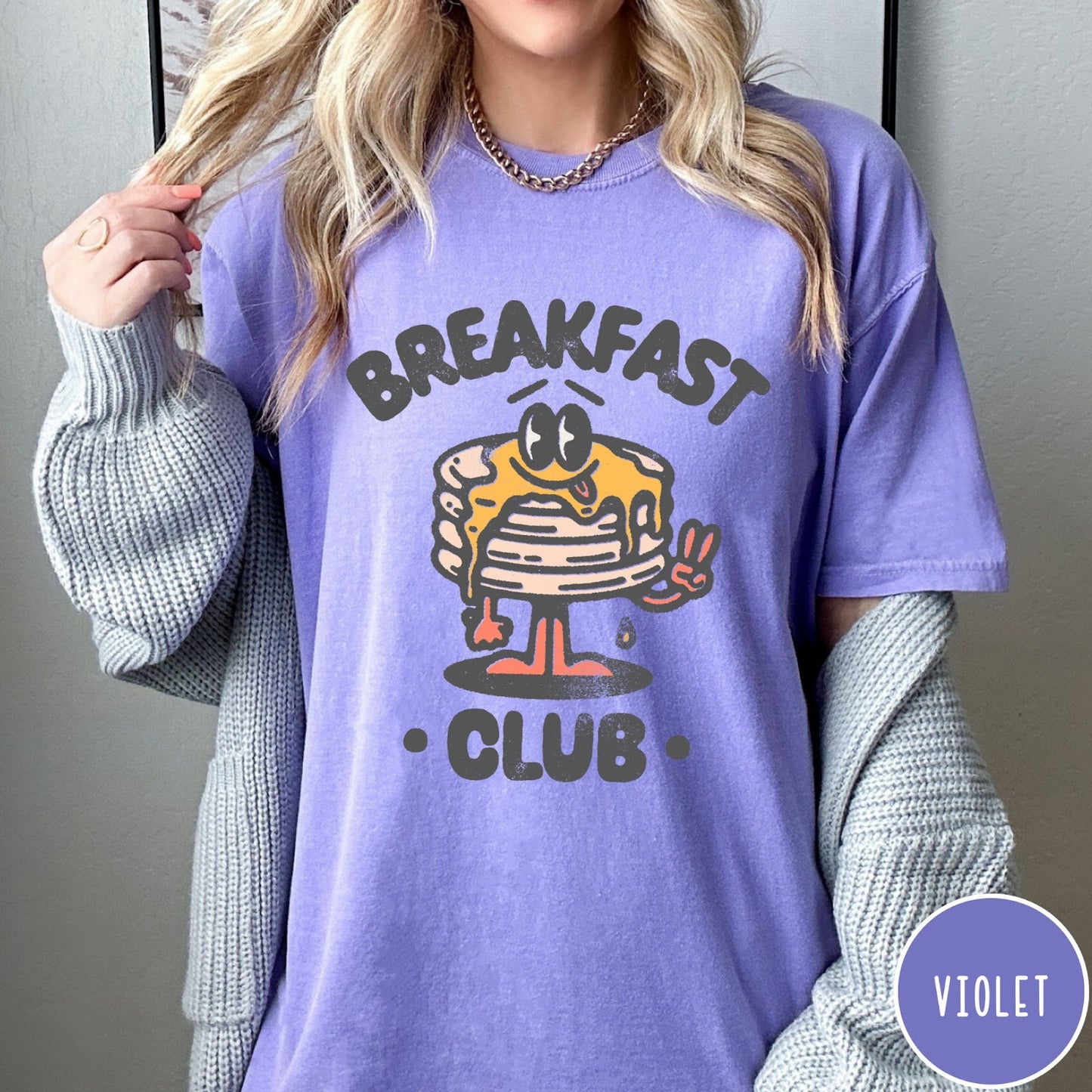 Comfort Colors tee in Violet featuring retro style graphic of a pancake character with syrup and peace sign