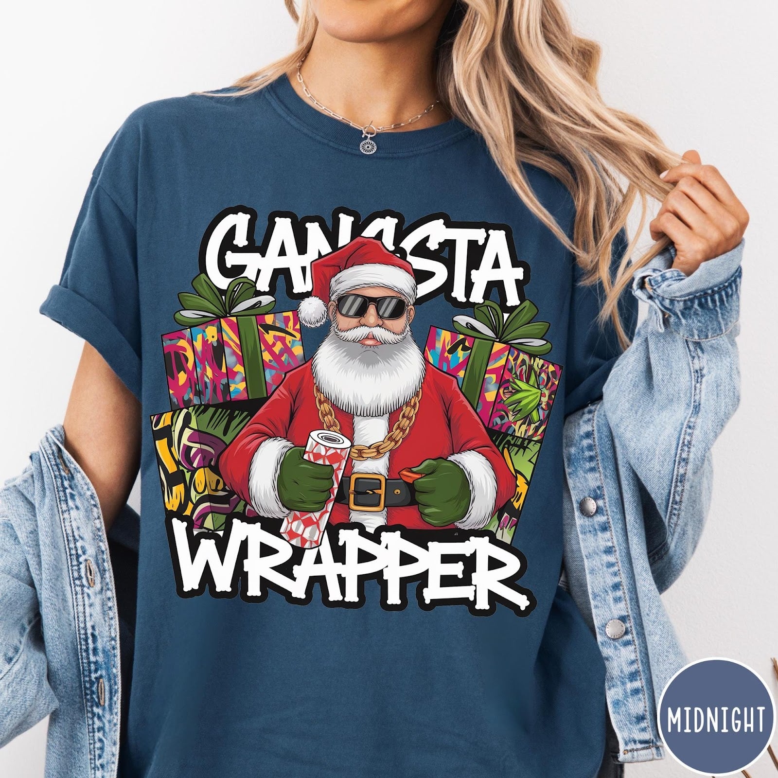 Comfort Colors tee in Midnight featuring cartoon style Santa Claus wearing sunglasses and gold chain holding wrapping paper