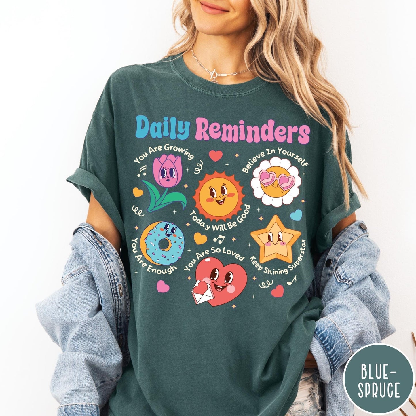 Comfort Colors tee in Blue Spruce featuring retro mascot design with daily affirmations and colorful cartoon characters