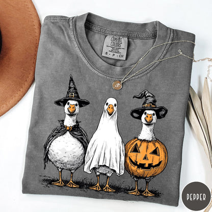 Comfort Colors tee in Pepper featuring Halloween graphic with three geese dressed as a witch, ghost, and pumpkin