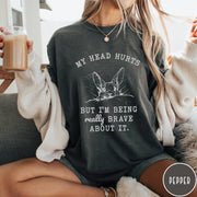 Comfort Colors tee in Pepper featuring line art graphic of a bunny resting its head on a pillow