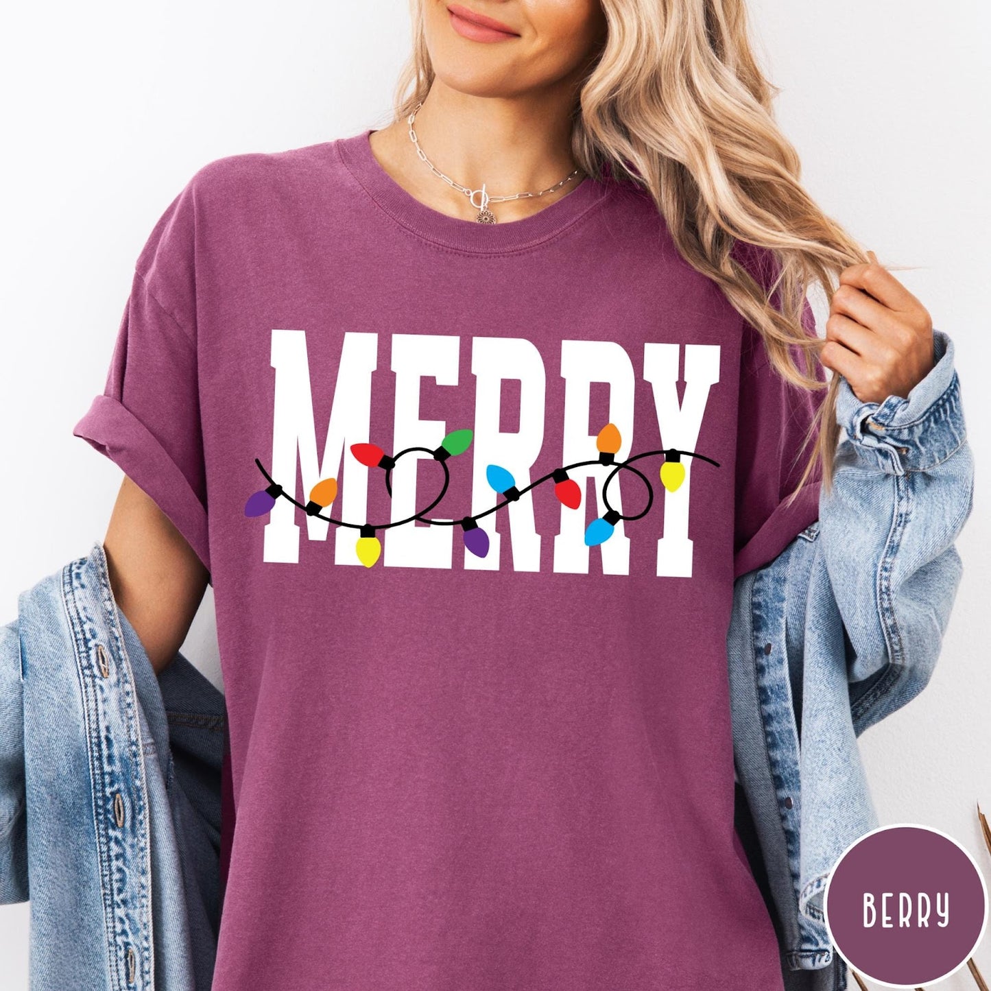 Comfort Colors tee in Berry featuring festive holiday style graphic with Merry text and Christmas lights