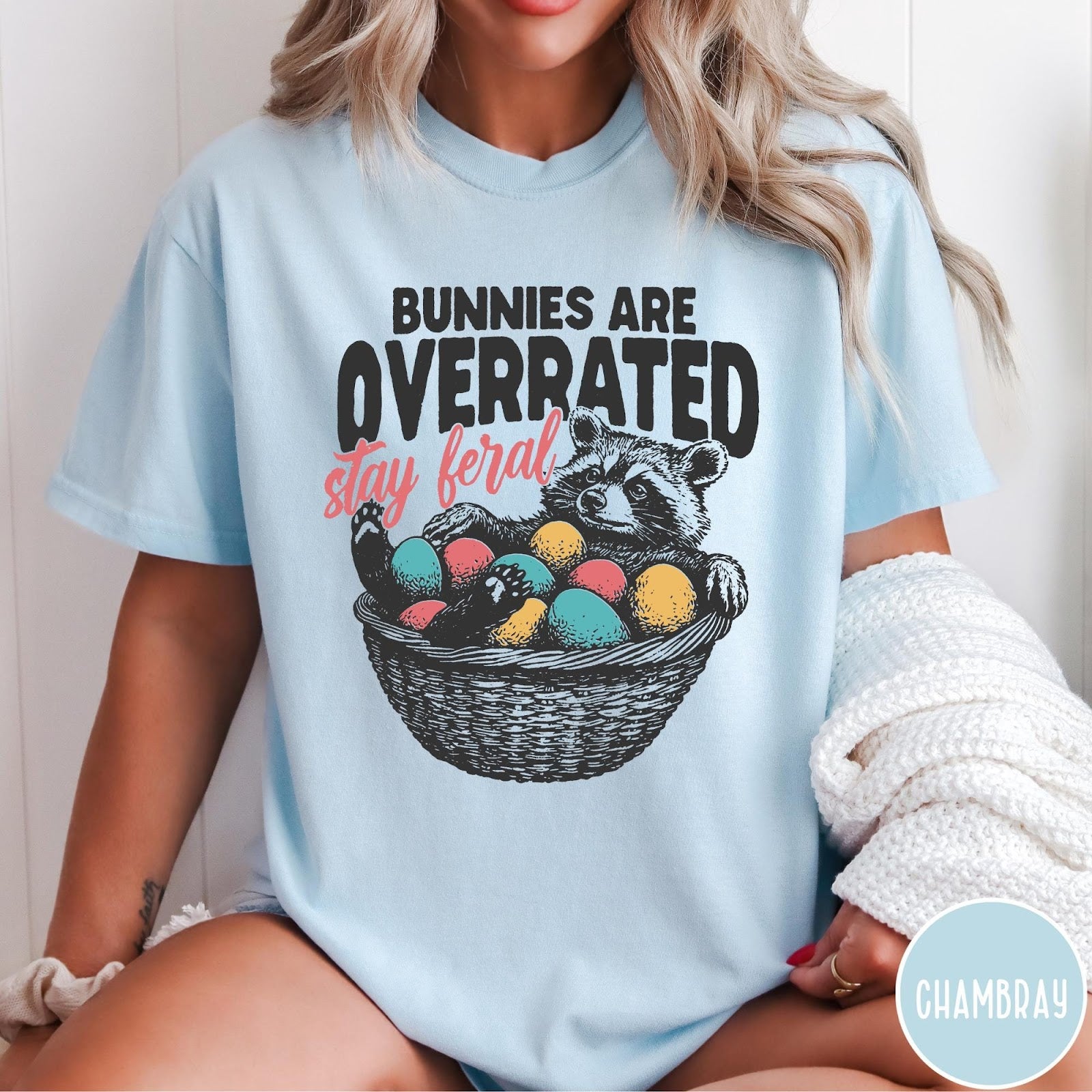 Comfort Colors tee in Chambray featuring graphic illustration of a raccoon sitting in an Easter basket