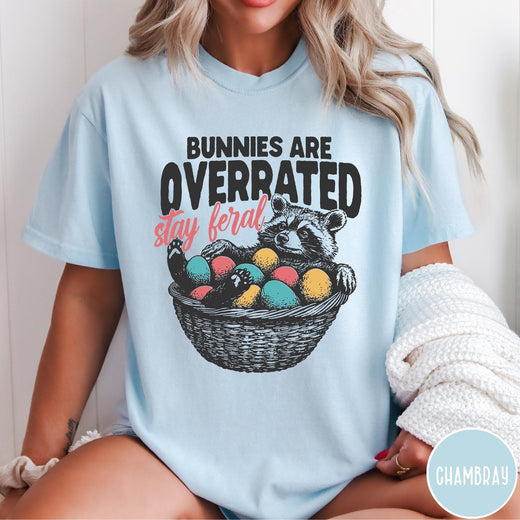 Comfort Colors tee in Chambray featuring graphic illustration of a raccoon sitting in an Easter basket