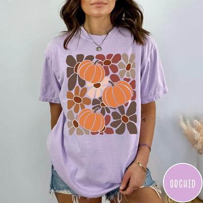 Comfort Colors tee in Orchid featuring boho floral style graphic with three orange pumpkins and brown flowers