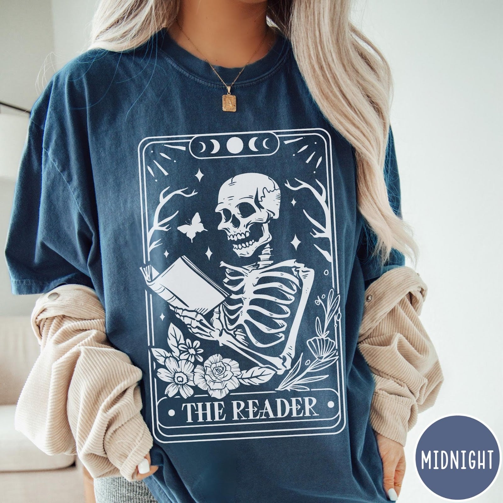 Comfort Colors tee in Midnight featuring tarot card style graphic of a skeleton reading a book