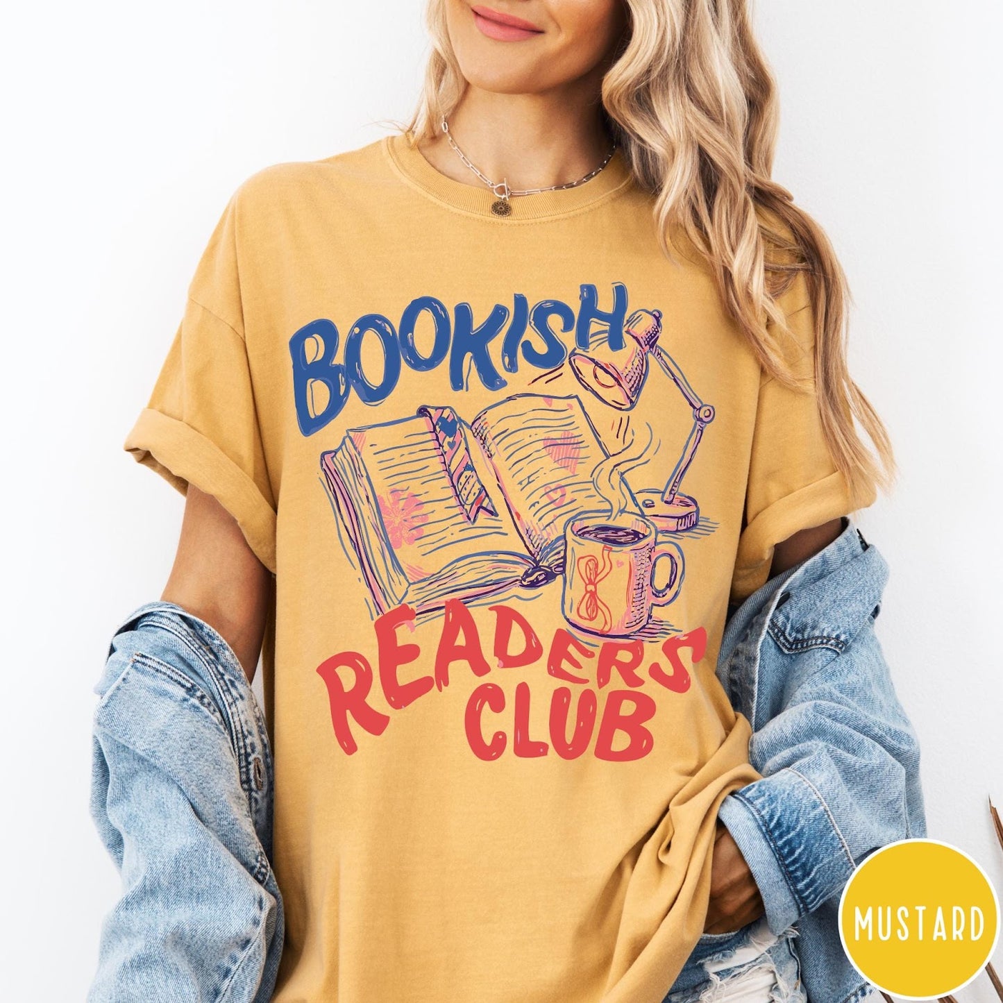Comfort Colors tee in Mustard featuring bookish reading graphic with open book, lamp, and coffee mug