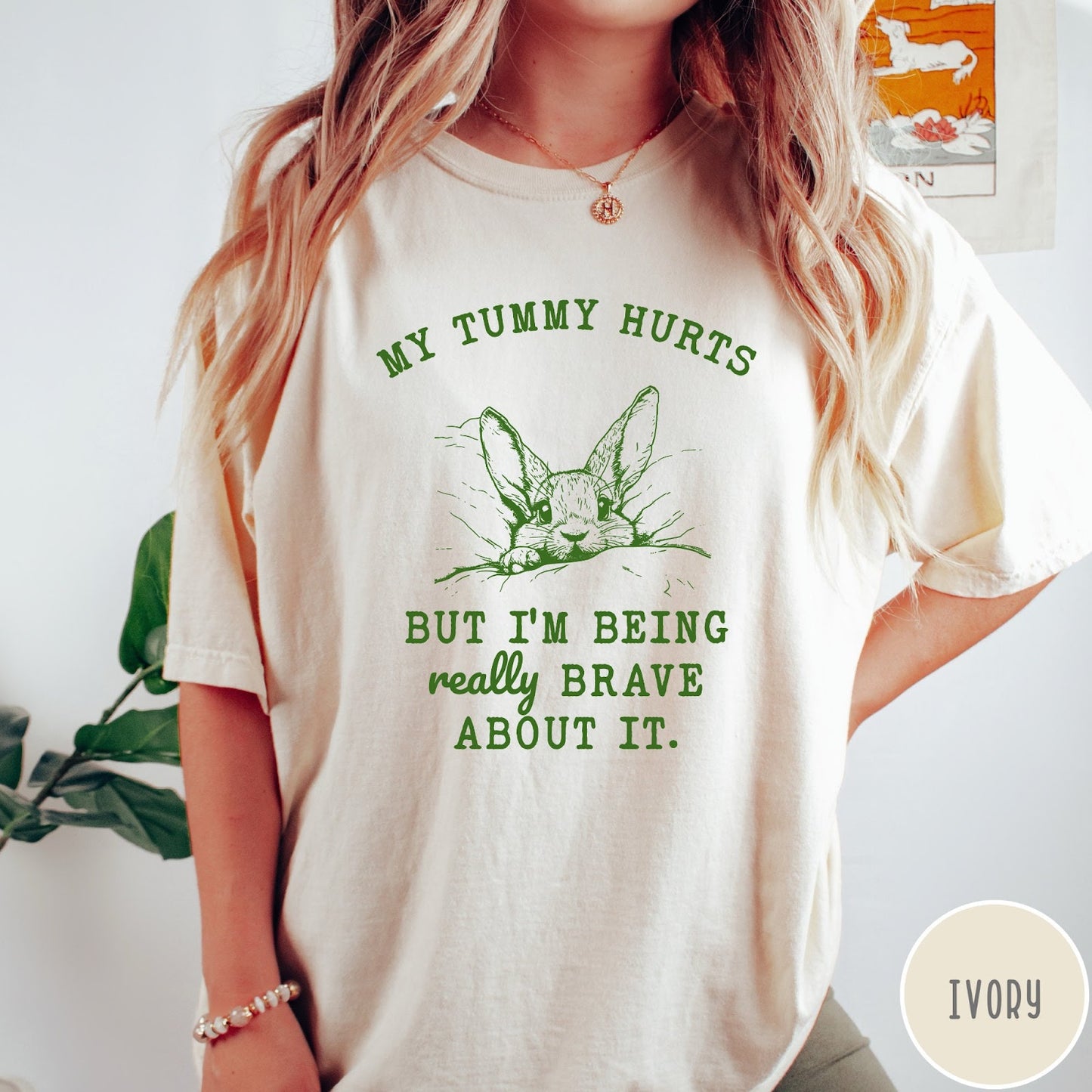 Comfort Colors tee in Ivory featuring line art graphic of a bunny with text My Tummy Hurts