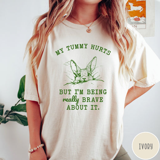 Comfort Colors tee in Ivory featuring line art graphic of a bunny with text My Tummy Hurts
