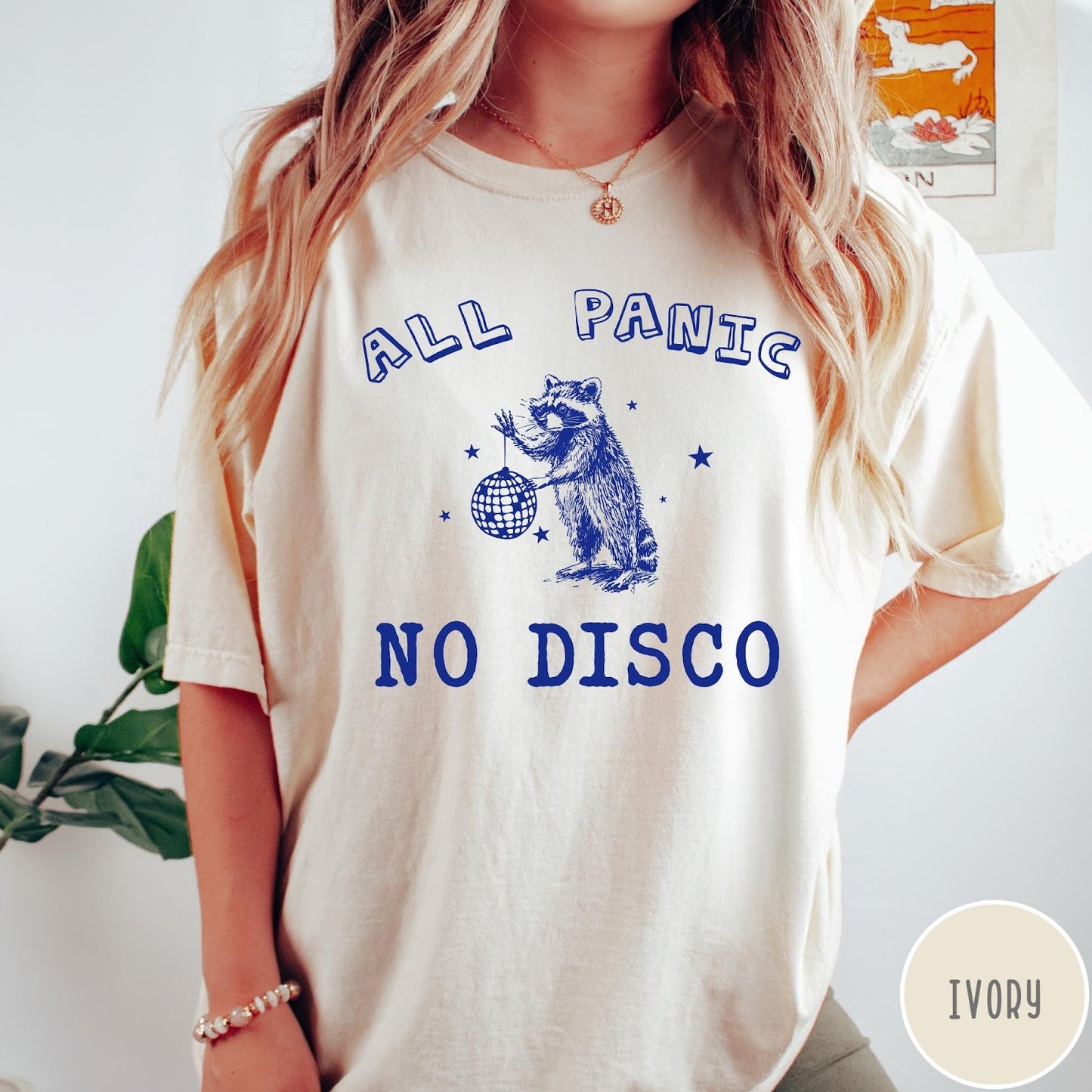 Comfort Colors tee in Ivory featuring screen printed raccoon graphic holding a disco ball with star accents