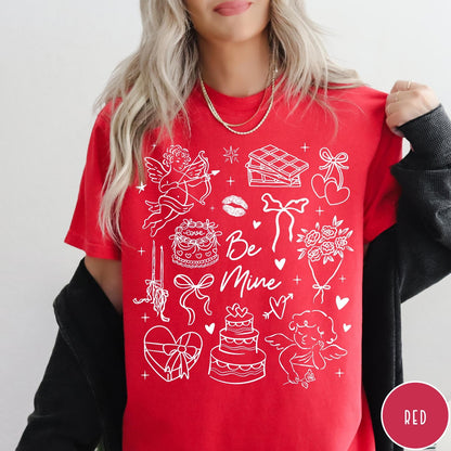 Comfort Colors tee in Red featuring Valentine's Day collage design with cupid, cake, flowers, and chocolate graphics