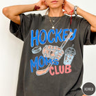 Comfort Colors tee in Pepper featuring lifestyle graphic design with hockey glove, stick, puck, and iced coffee