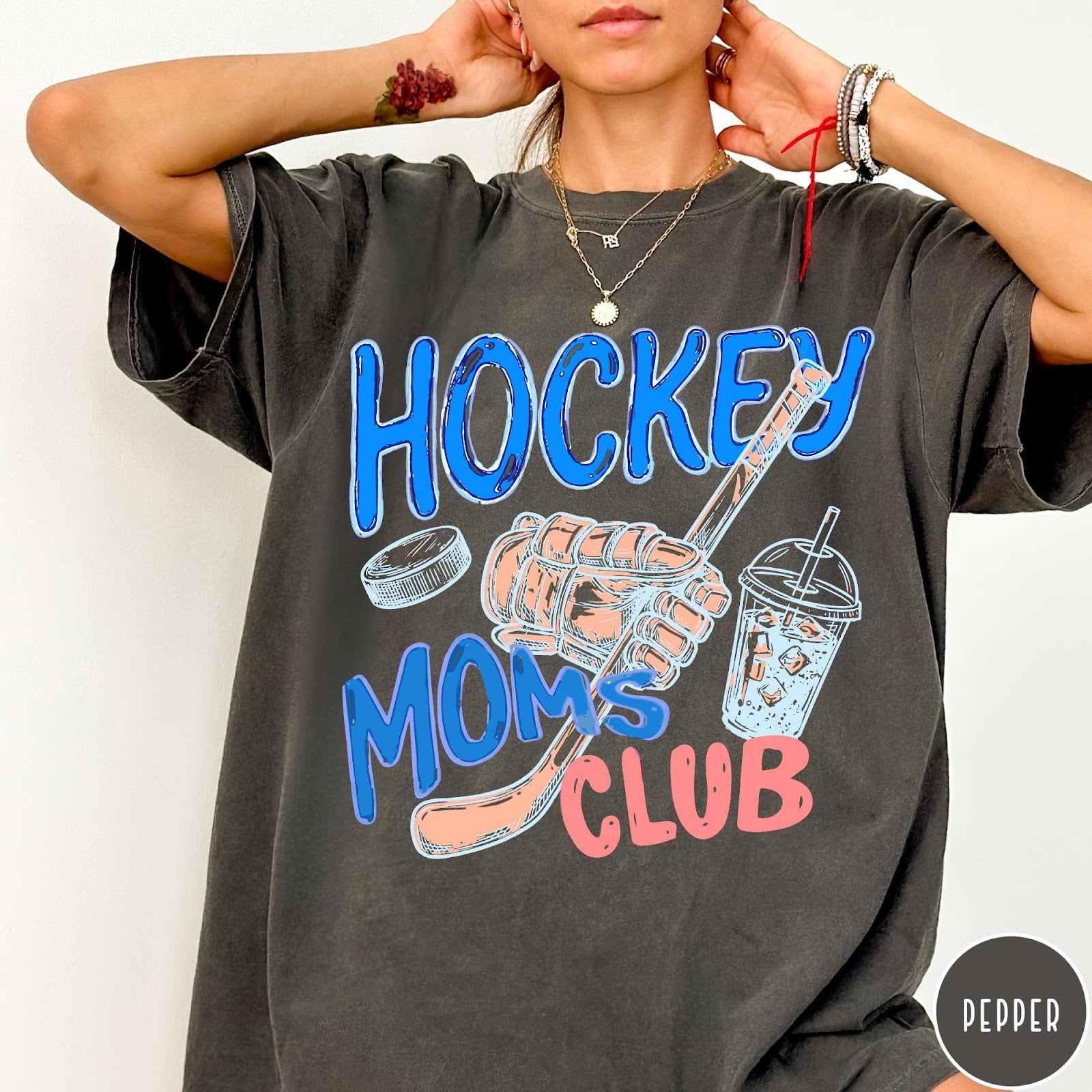 Comfort Colors tee in Pepper featuring lifestyle graphic design with hockey glove, stick, puck, and iced coffee