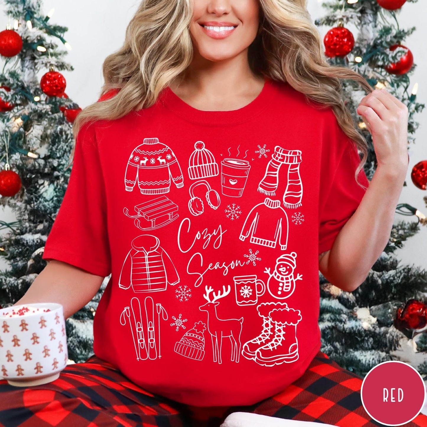 Comfort Colors tee in Red featuring winter activities graphic with sweaters, sled, snowman, and seasonal items.
