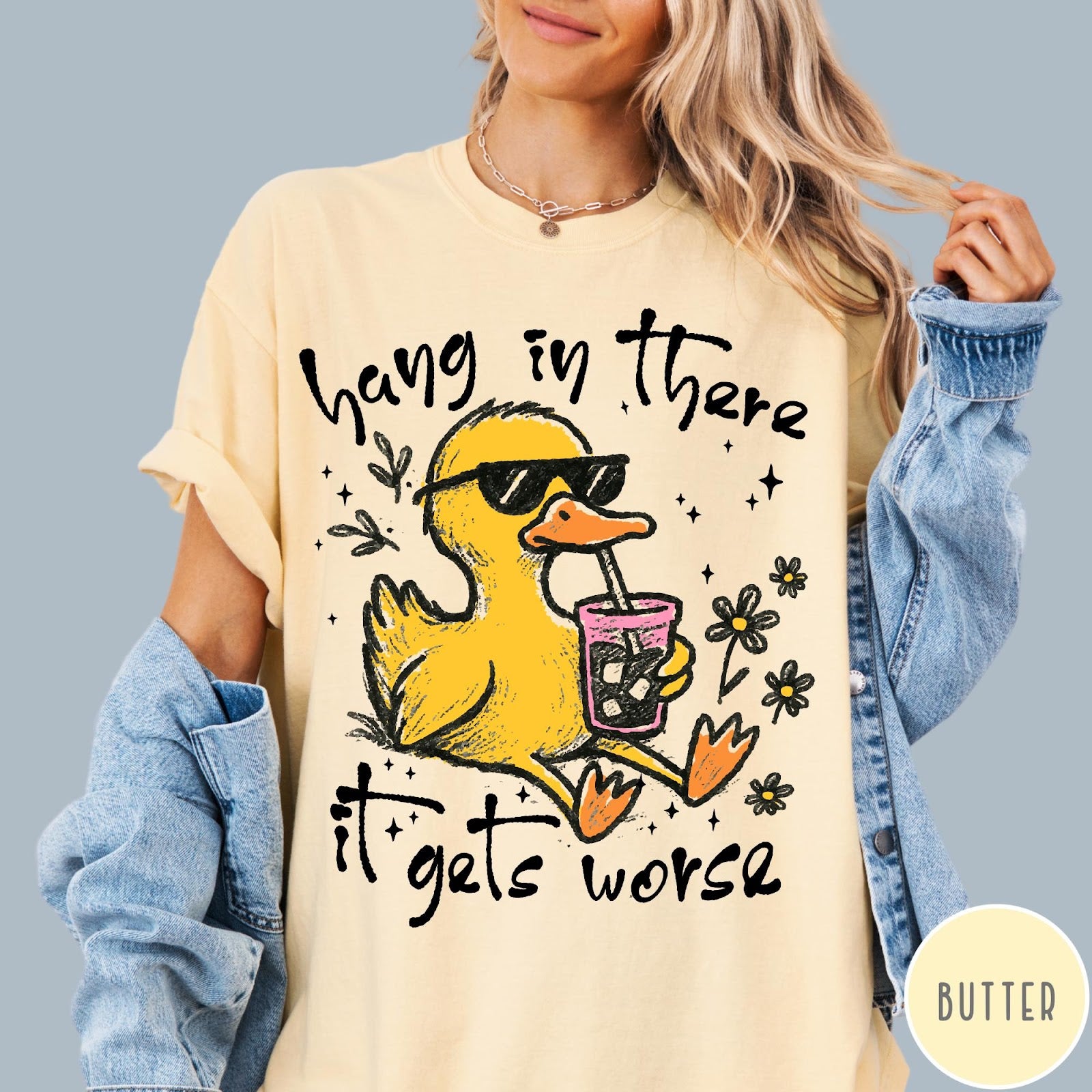 Comfort Colors tee in Butter featuring illustrated duck wearing sunglasses and drinking iced coffee with floral accents