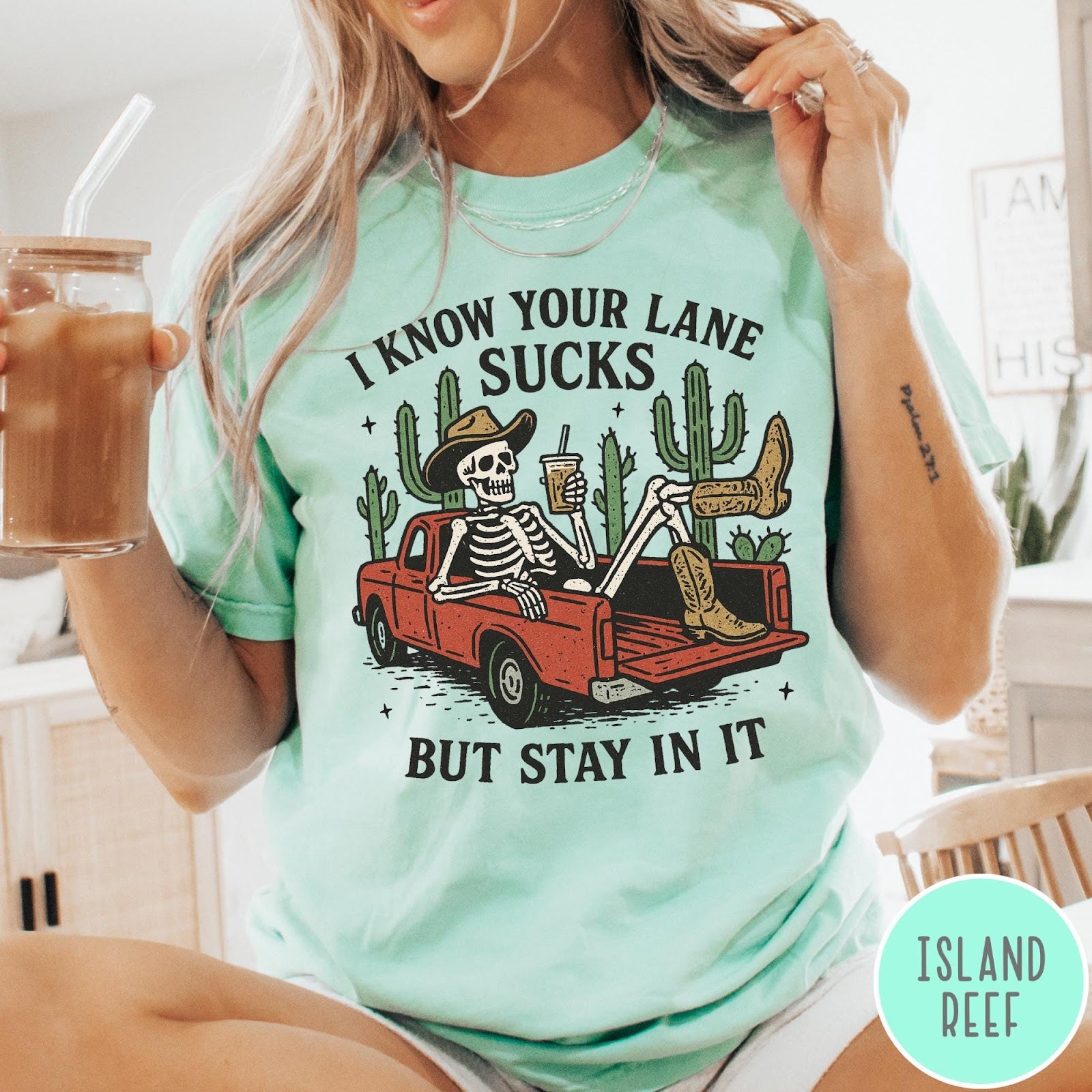 Comfort Colors tee in Island Reef featuring western skeleton design with cowboy hat and boots in truck bed