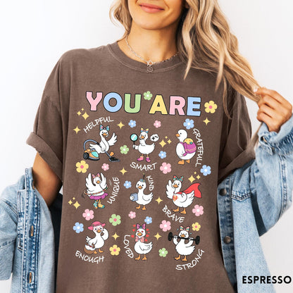 Comfort Colors tee in Espresso featuring cute cartoon duck graphic with inspirational words like kind and brave