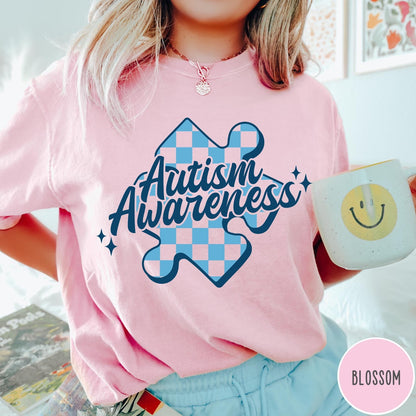 Comfort Colors tee in Blossom featuring casual style with a blue checkered puzzle piece Autism Awareness graphic