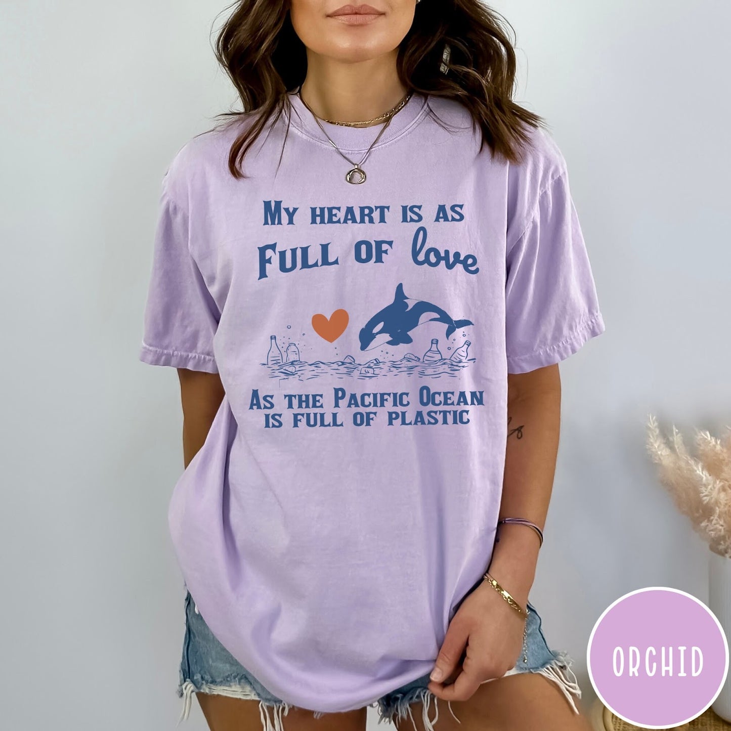 Comfort Colors tee in Orchid featuring screen printed orca and plastic pollution graphic with ocean conservation text