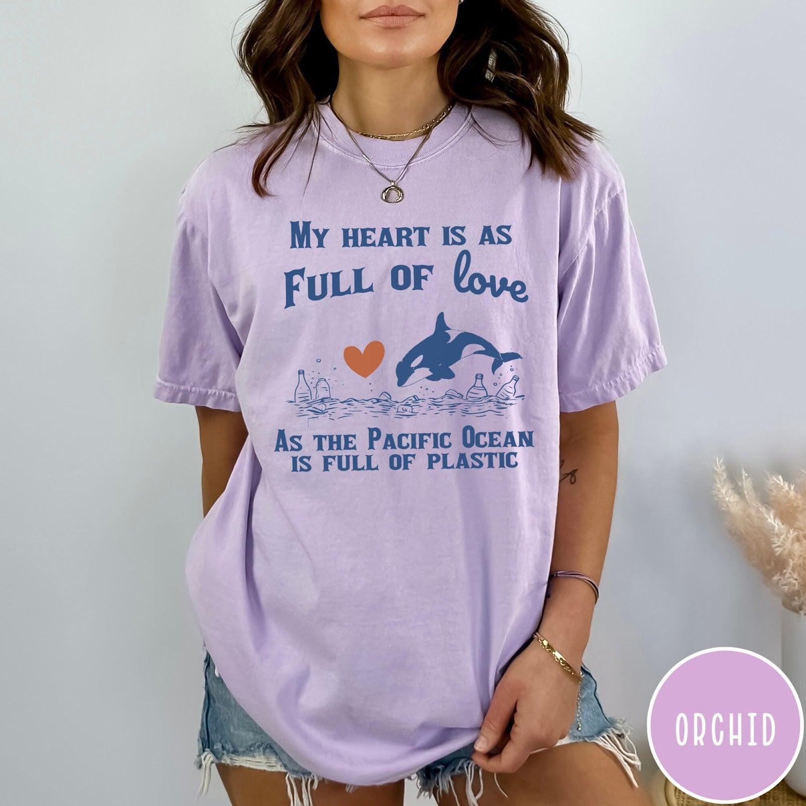 Comfort Colors tee in Orchid featuring screen printed orca and plastic pollution graphic with ocean conservation text