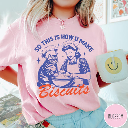 Comfort Colors tee in Blossom featuring vintage style graphic of a woman and cat baking biscuits together
